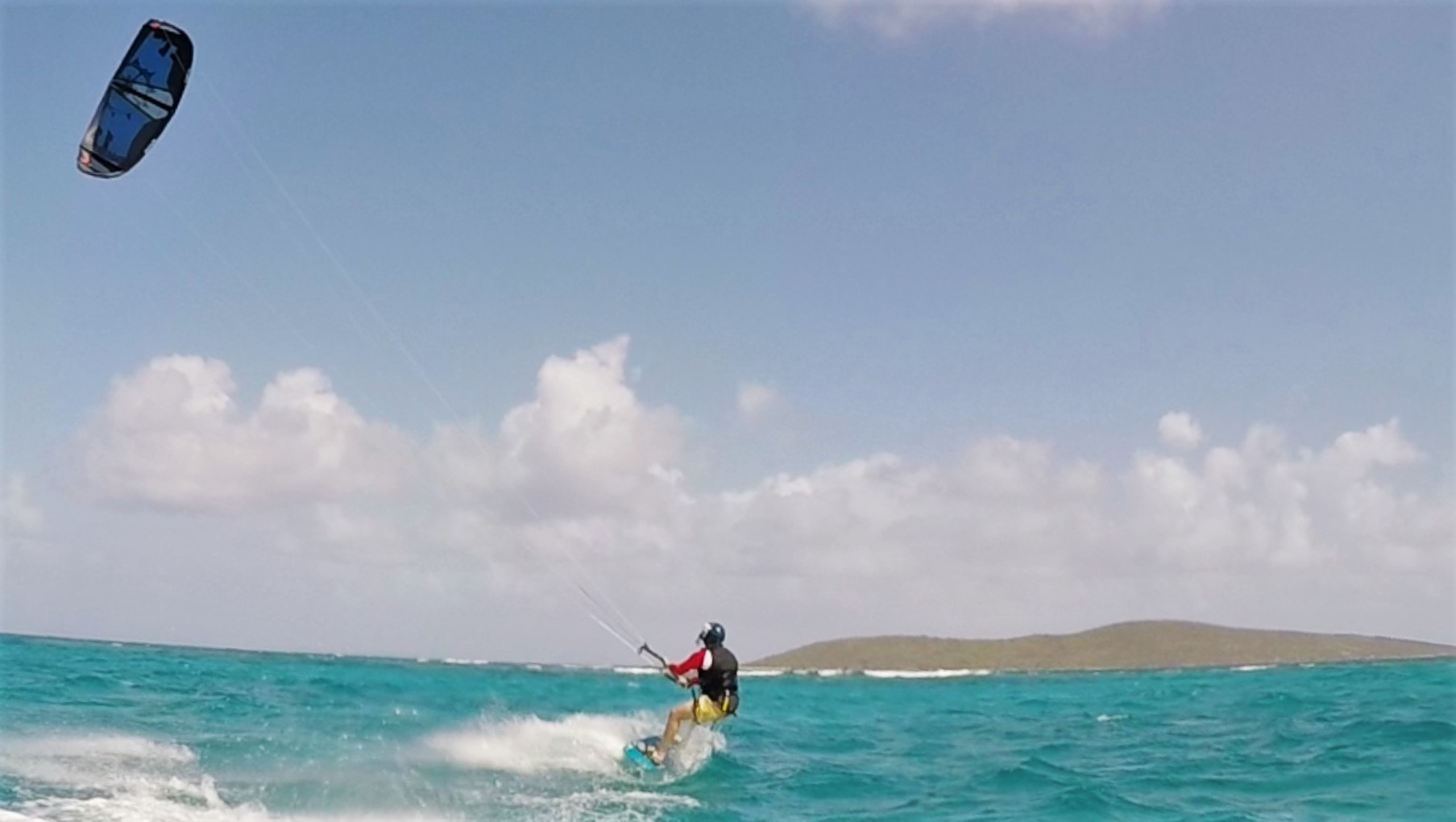 Kiteboarder cruising through the caribbean sea